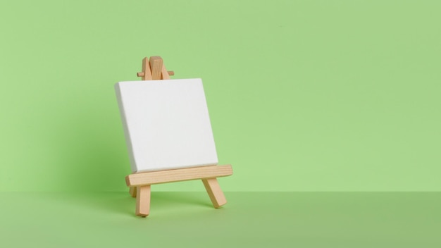 Mini painting on an easel on a green background at an angle