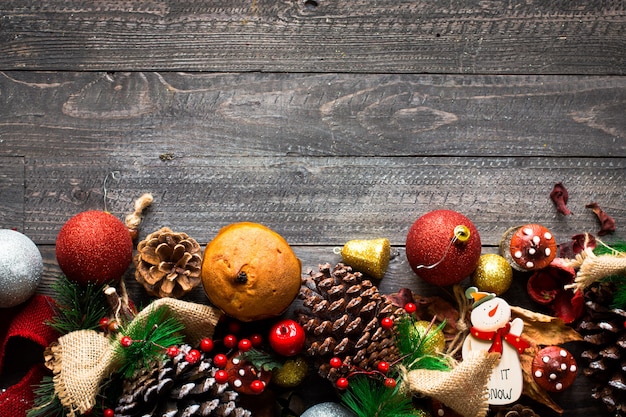 Mini panettone with fruits and Christmas decoration, wooden background