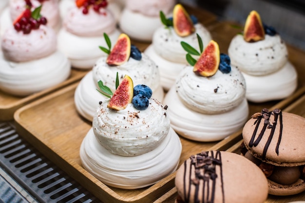 Mini Pavlova dessert on a candy bar wedding buffet table cakes decorated berries and fruits