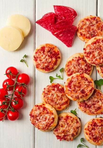 Mini pizzas salami with mozzarella cheese on a white table top view no people