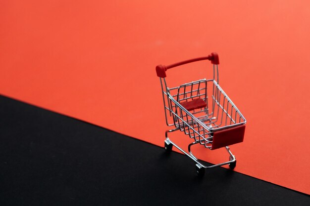 Mini red shopping cart shop concept Empty top view mini shopping cart or trolley shopping on background concept shopping in supermarket