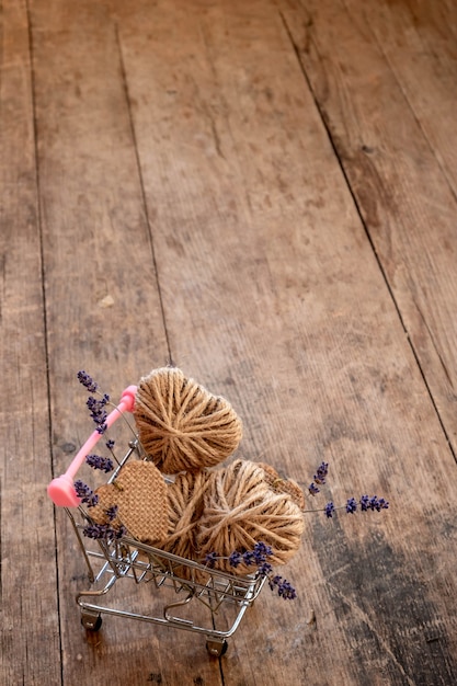 Mini shopping cart filled with do it yourself jute hearts and lavender flowers