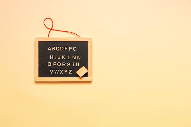 Miniature blackboard and letters of the English alphabet.