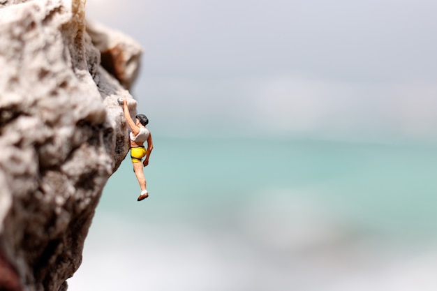 Miniature climber on a rock