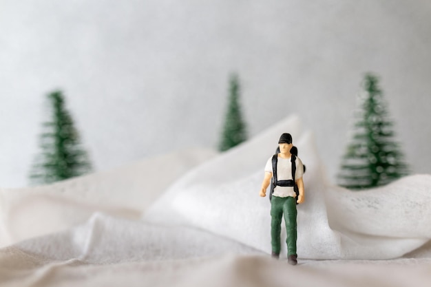 Miniature people Backpacker Travel in winter time