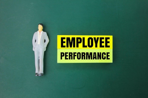 miniature people and colored paper with the word Employee performance