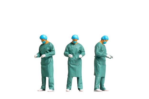 Photo miniature people full length portrait of young doctor in scrubs isolated on white background with clipping path