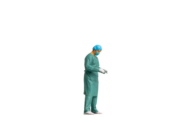 Miniature people Full length portrait of young doctor in scrubs Isolated on white background with clipping path