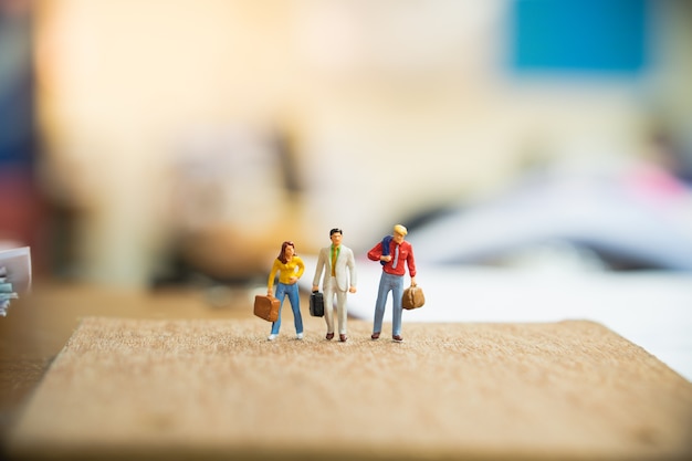 Miniature people, man and woman on travel, using for business concept