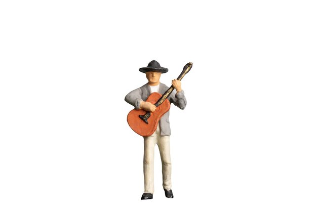 Miniature people Musician with guitar isolated on white background with clipping path