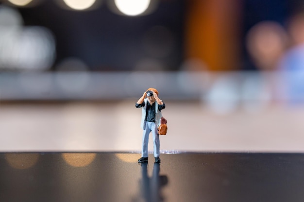 Miniature people Photography holding a camera and copy space for text