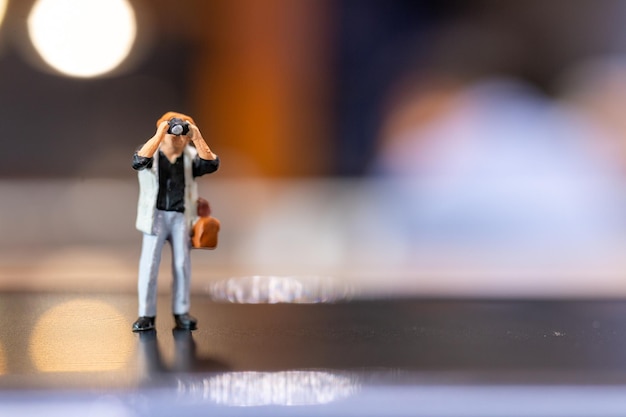 Miniature people Photography holding a camera and copy space for text