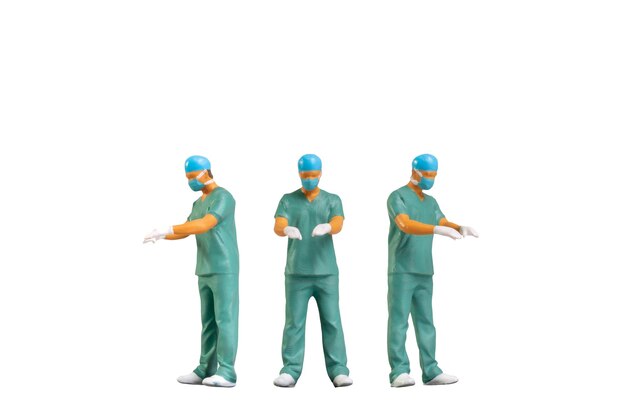 Photo miniature people portrait of young doctor in scrubs isolated on white background with clipping path