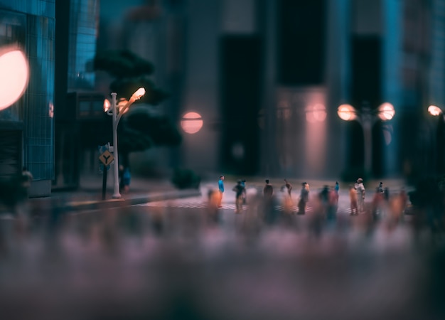 Miniature people walking on streets, people are moving across the pedestrian crosswalk