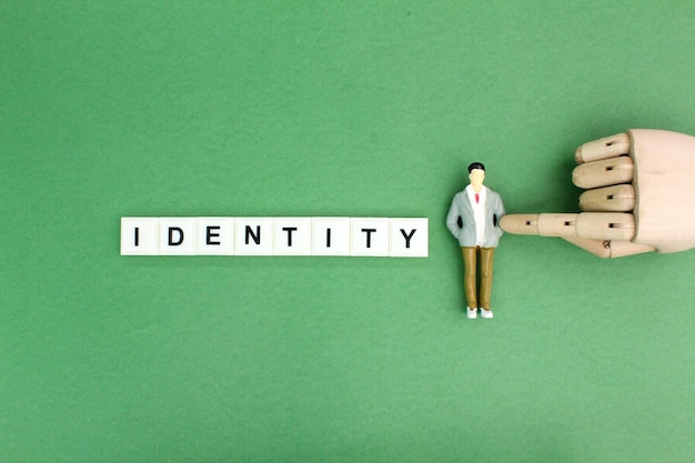 miniature people with the word Identity the concept of a person's identity or a company's identity