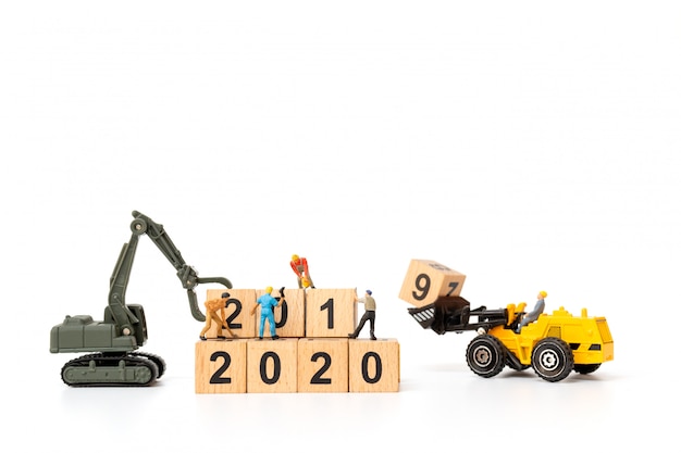 Miniature people : Worker team create wooden block number 2020