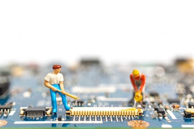 Miniature people working on cpu board