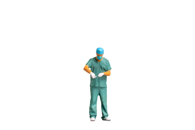 Photo miniature people young doctor in scrubs isolated on white background with clipping path