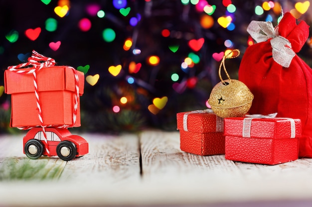 Miniature Red Car Carrying a big red box. Holiday Merry Christmas concept.