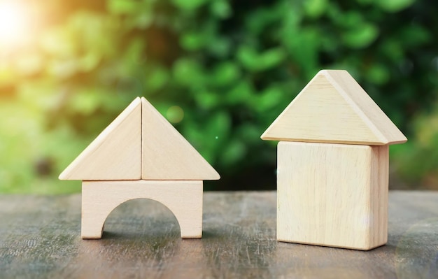 miniature wood house model on wood and green natural background.