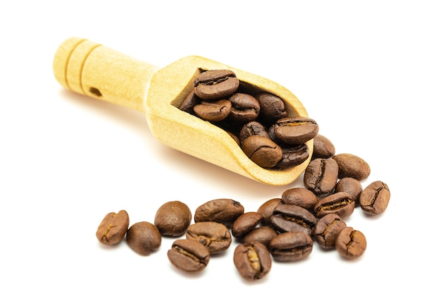 Miniature workers loading coffee beans to wooden scoop spoon. Coffee time concept.