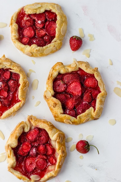 Minibiscuits made of strawberries on a white background Delicious minipies Top view