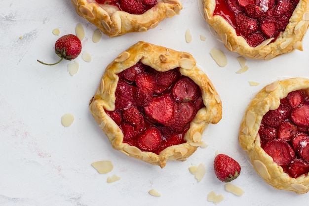 Minibiscuits made of strawberries on a white background Delicious minipies Top view