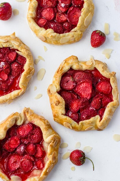 Minibiscuits made of strawberries on a white background Delicious minipies Top view