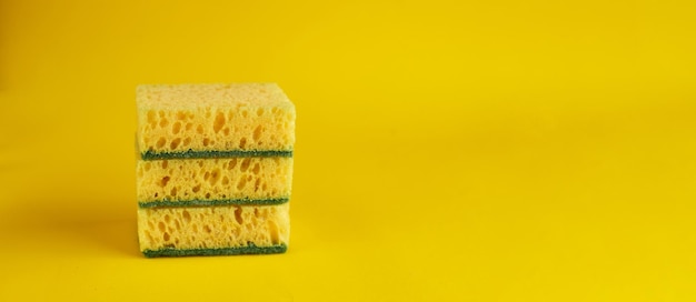 Minimal background with yellow sponges for washing dishes Trendy yellow background