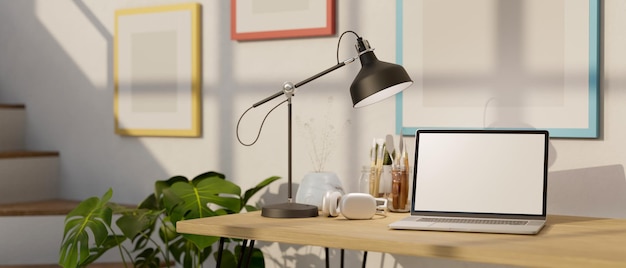 Minimal home workspace with laptop mockup table lamp headphones and painting tools on table