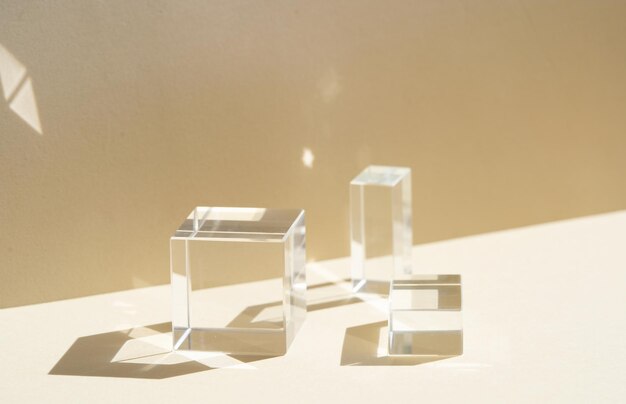 Minimal modern product glass display on textured background in neutral earth tones with shadows