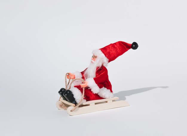 Minimal New Year concept of Santa Claus on sleigh Creative winter holiday idea Merry Christmas