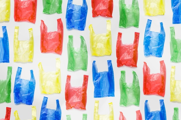 Minimal pattern of bright colorful plastic bags on light background Biodegradable packaging waste