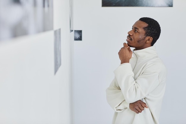 Minimal Side View Portrait Of Black Young Man In Art Exhibition