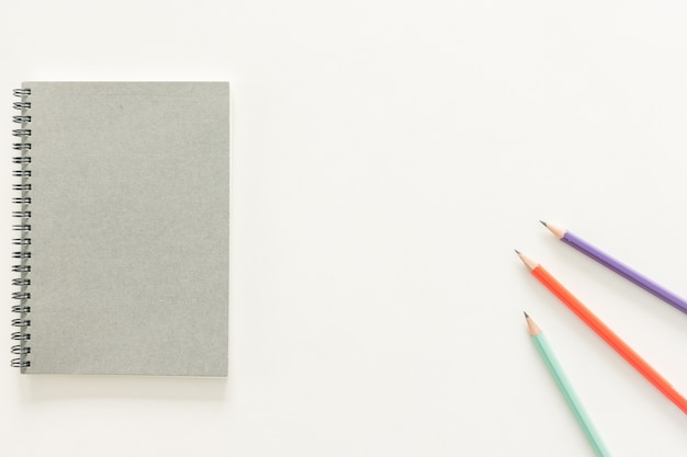 Minimal work space - Creative flat lay photo of workspace desk with sketchbook and wooden pencil on copy space white background. Top view , flat lay photography.