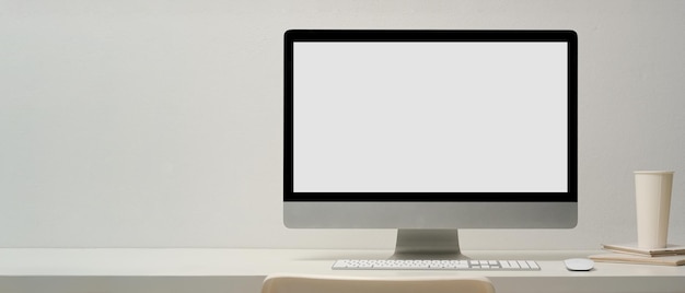 Minimal workspace or workstation interior with modern pc computer with white desktop screen mockup