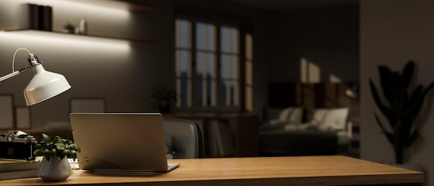 Minimalist home workspace at night with laptop table lamp and copy space on wood table