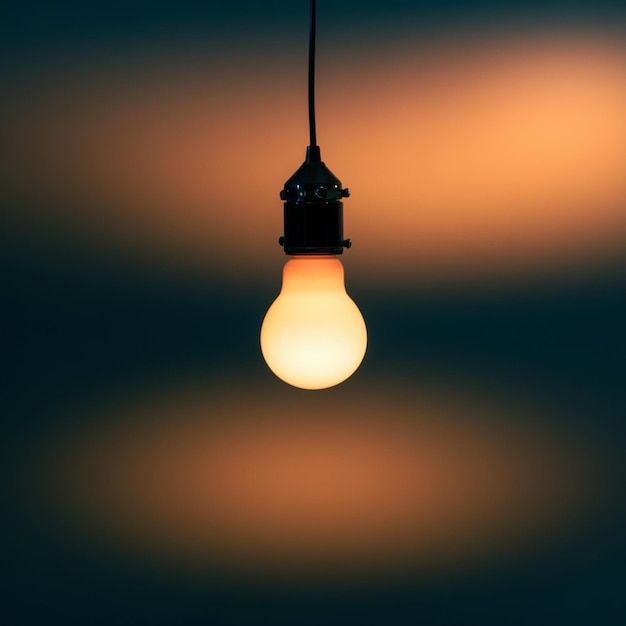 Photo minimalist light bulb hanging from wire emitting soft glow against gradient