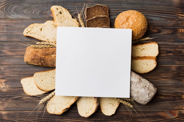 Minimalist paper blank mockup on background of Types of homemade bread Different kinds of fresh bread as background top view with space for your text or design