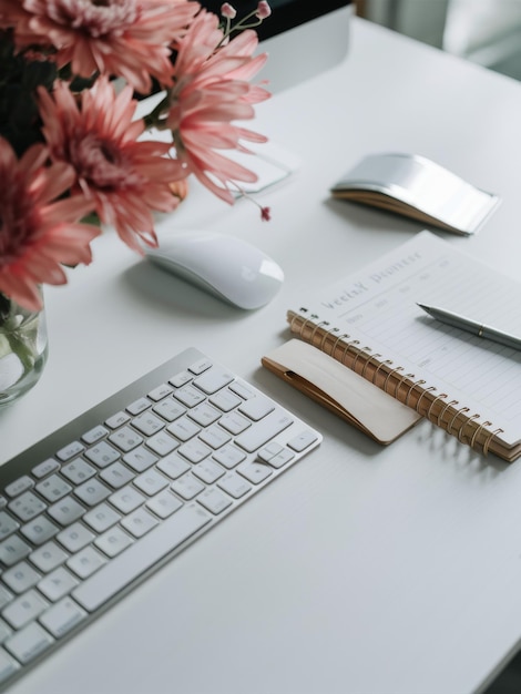 Photo minimalist workspace with computer weekly planner and pink flowers for productive home office setup