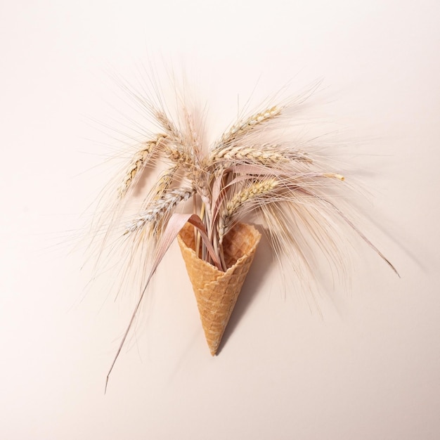 Minimalistic concept of ice cream from an ear of wheat On a beige background