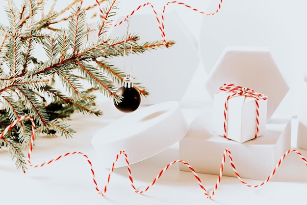 Minimalistic eco friendly scandinavian christmas background in white colors Fir branches and white empty podium