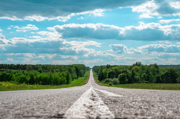 Minimalistic landscape of asphalt road in the cracks of the distant horizon