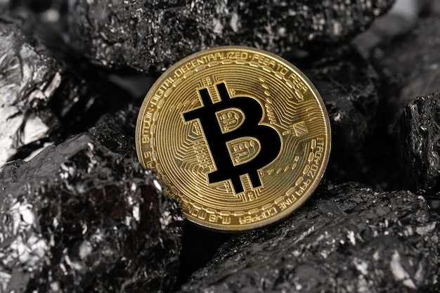 Mining bitcoin cryptocurrency on a pile of fossil fuels in the form of coal