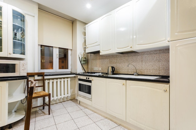 MINSK BELARUS DECEMBER 8 2017 Interior of the modern kitchen and guest hall in loft flat in light color style