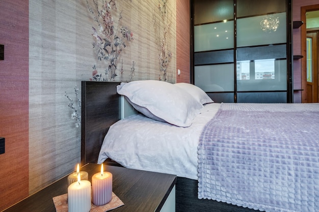 MINSk BELARUS JULY 2021 Interior of the modern luxure bedroom in studio apartments with candles