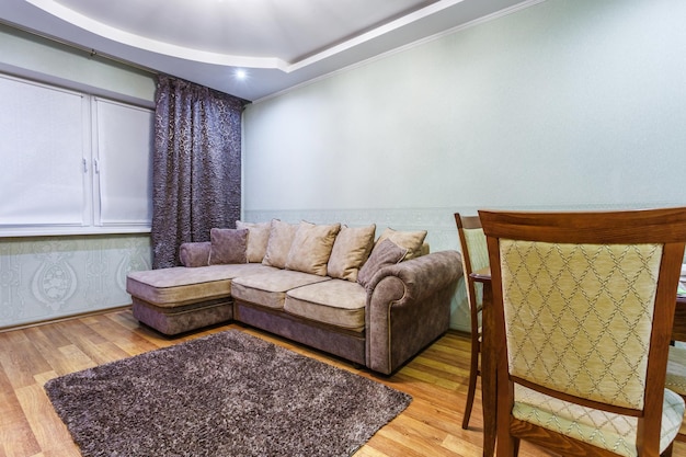 MINSK BELARUS OCTOBER 2020 Interior of the modern guestroom in small studio apartments with sofa and tv