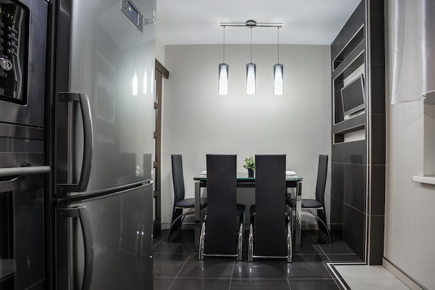 MINSK BELARUS SEPTEMBER 2019 Interior of the modern luxure kitchen with guest table in studio apartments in minimalistic black color style