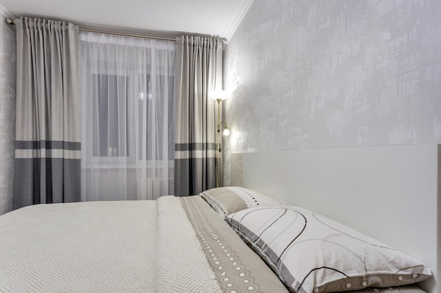 MINSK BELARUS SEPTEMBER 2020 Interior of the modern luxure bedroom in studio apartments in light color style