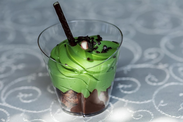 Mint and chocolate cream in a small cup with fruits